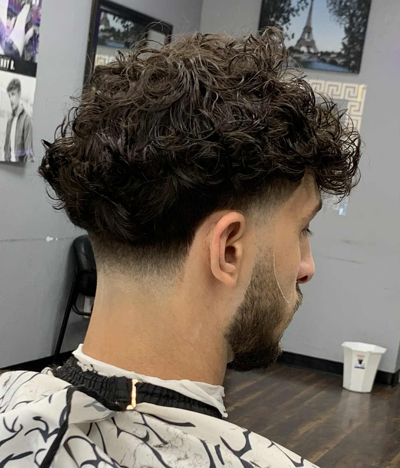 Low taper fade with long natural curls left on top